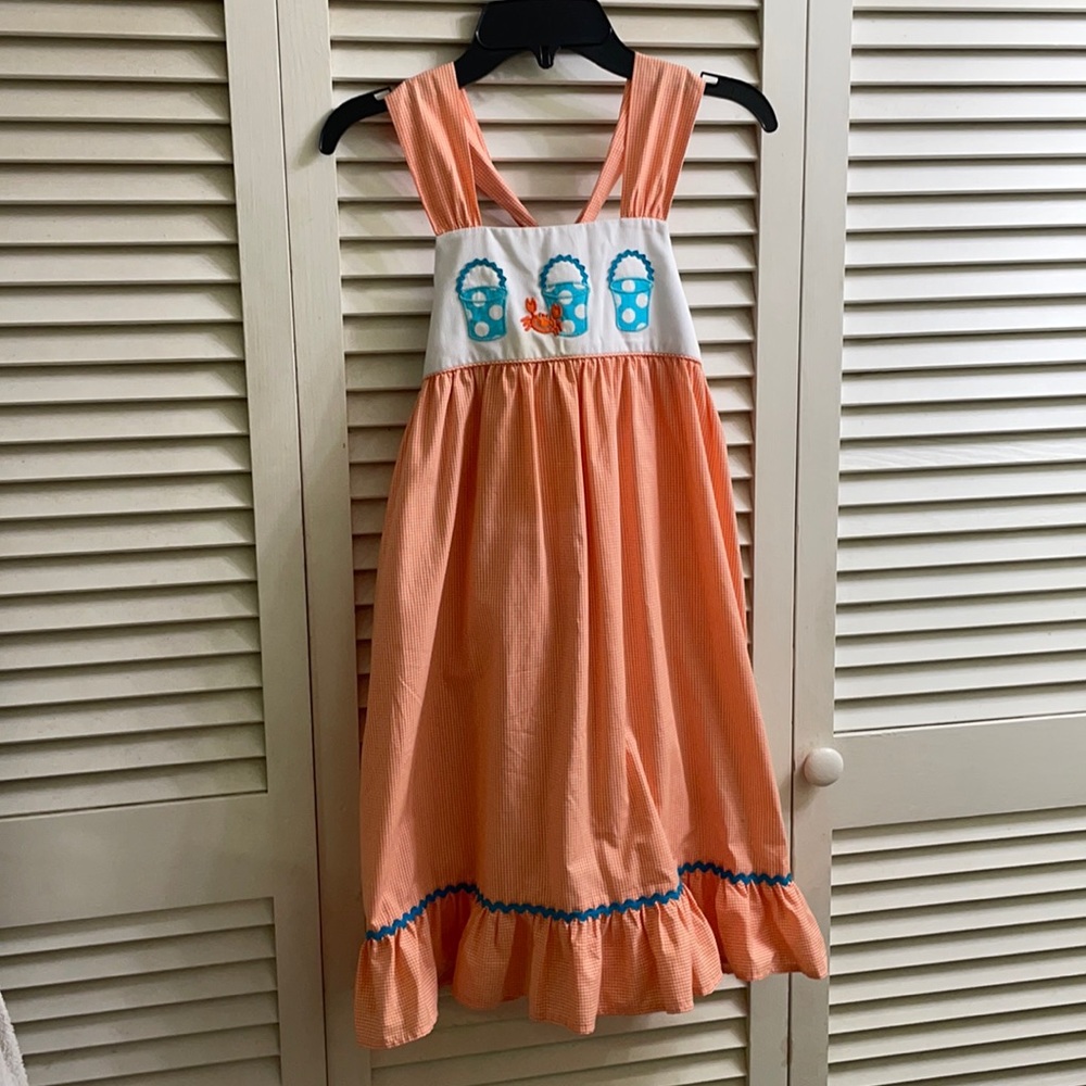 Kelly’s Kids dress with buckets and crab, ties in the back. Worn once